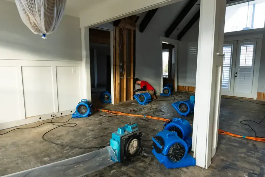 Restoration technician extracting standing water from a flooded Snellville, GA home