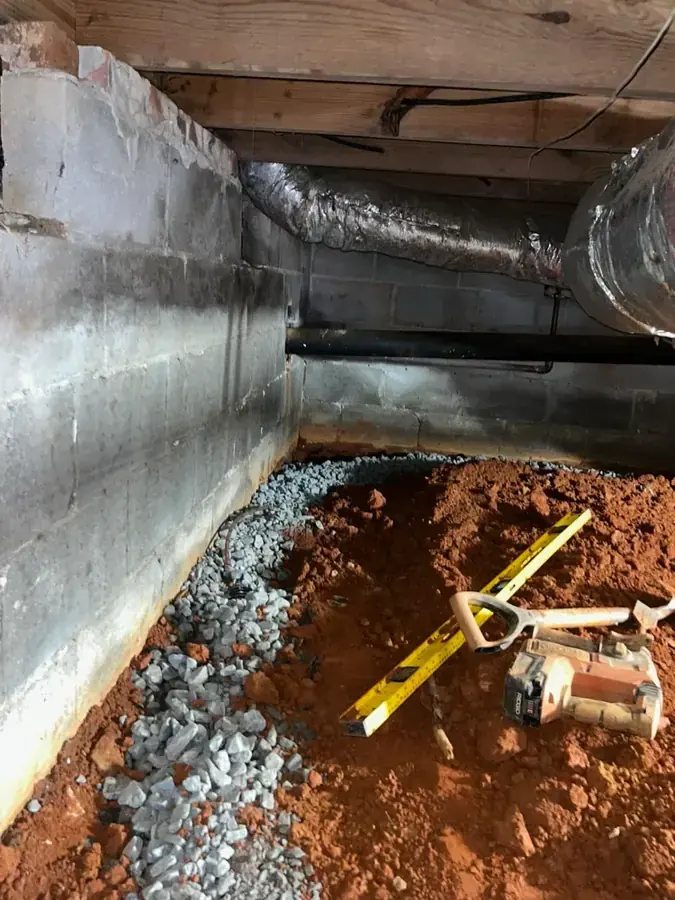 Technician drying a wet crawl space under a Snellville home